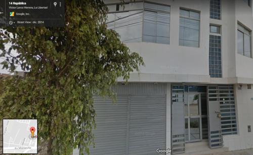 a building with a garage door in front of it at Hospedaje Harjeny in Trujillo