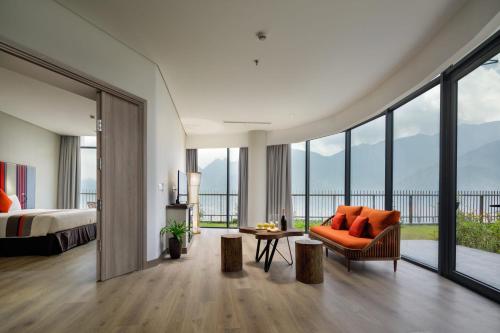 a bedroom with a bed and a couch and a table at Pao's Sapa Leisure Hotel in Sa Pa