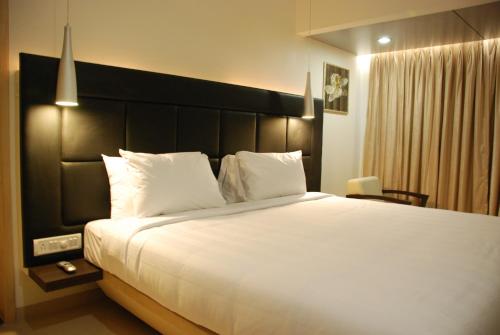 Posteľ alebo postele v izbe v ubytovaní The Oriental Residency