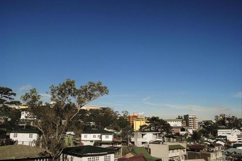 a view of a city with buildings and trees at Hotel 45 in Baguio