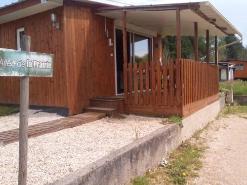 a wooden house with a sign in front of it at eurl de l'écluse in Inor