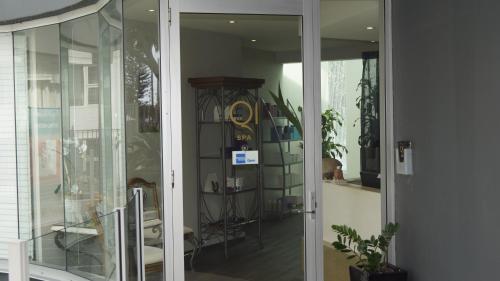 a room with a glass door and a shelf with plants at Private Apartment with Ocean Views at Q1 Resort in Gold Coast