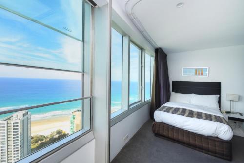 a bedroom with a bed and a view of the ocean at Private Q1 Resort & Spa Apartment with Ocean Views in Gold Coast