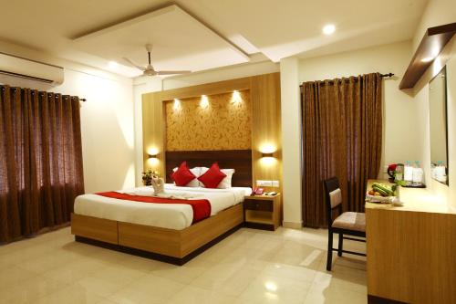 a bedroom with a large bed with red pillows at Prayana in Cochin