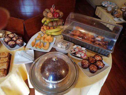 a table filled with lots of different types of pastries at Hotel Agathae in Catania