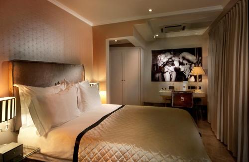 a hotel room with a large bed and a large window at Hotel B Berdichevsky in Tel Aviv