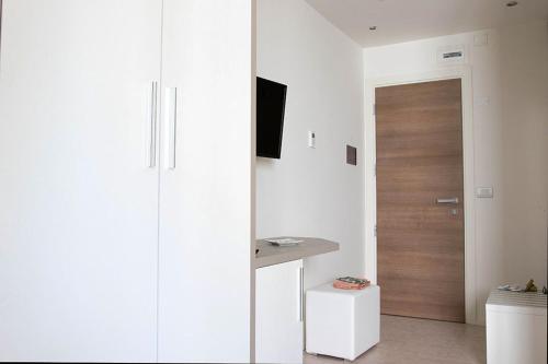 a room with a door and a room with a table at Hotel Monica in Riccione