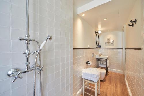 a bathroom with a shower and a toilet and a sink at MHOUSE Boutique Hotel Palma in Palma de Mallorca