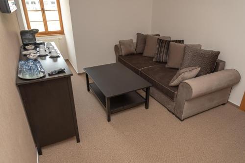 a living room with a couch and a table at Penzion Fojtstvi in Olomouc