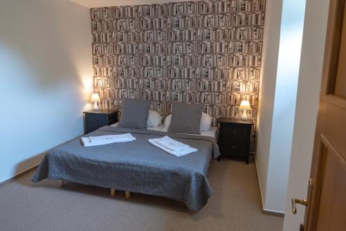 a bedroom with a bed with two towels on it at Penzion Fojtstvi in Olomouc