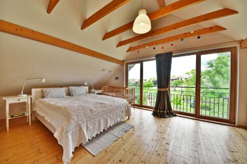 a bedroom with a bed and a large window at Atostogų namelis Druskininkuose in Druskininkai