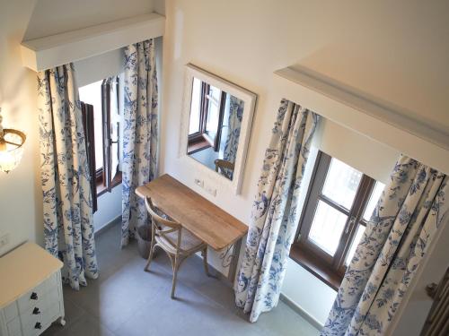 a small desk in a room with two windows at Le Sei Dame in Bardi