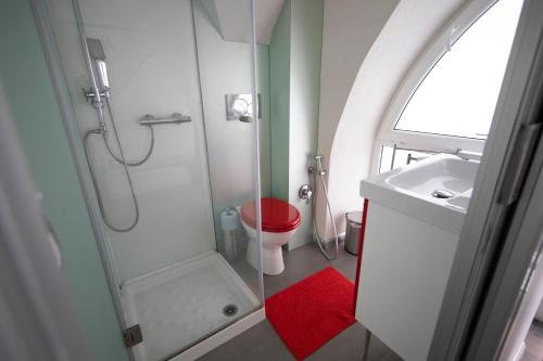 a bathroom with a shower and a toilet and a sink at Casa Nutrizione Apartment in Catania
