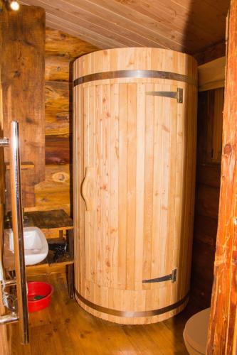a wooden barrel in a room with a toilet at Les Cabanes Du Saleve in Collonges-sous-Salève