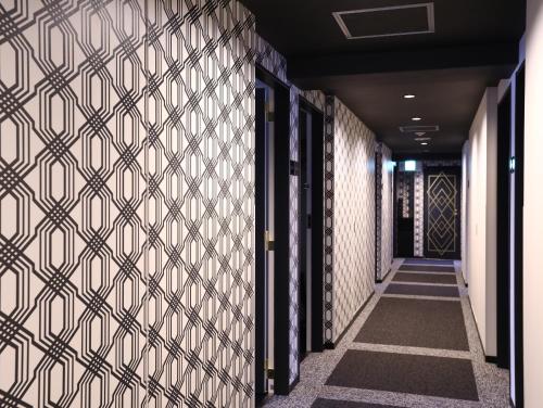 a hallway with a patterned wall in a building at Hotel Wing International Select Osaka Umeda in Osaka