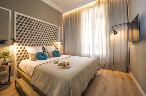 a bedroom with a large bed and a large window at Ona Hotels Mosaic in Barcelona