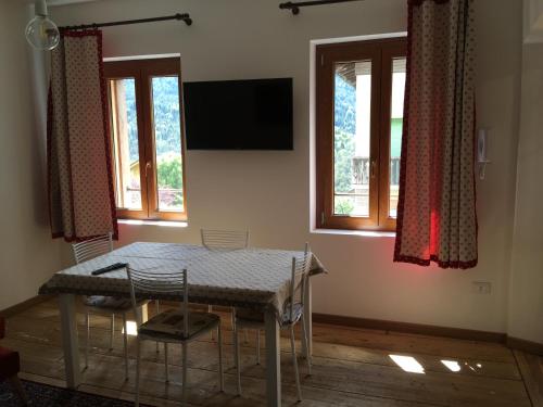 a table and chairs in a room with windows at Antica Casa Nella in Venas