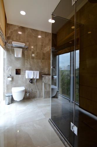a bathroom with a glass shower and a toilet at Maristella Marine Residence in Odesa