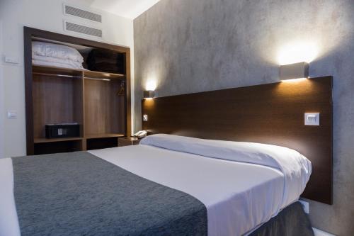 a hotel room with a large bed and a bunk room at Apartamentos Recoletos in Madrid