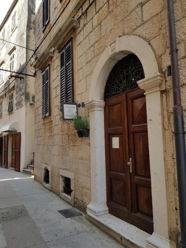 a large wooden door on the side of a building at San Teodoro in Korčula