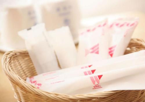 a basket filled with toilet paper and toiletries at Hotel Wing International Shonan Fujisawa in Fujisawa