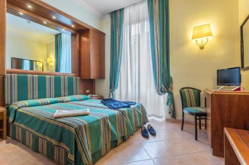 מיטה או מיטות בחדר ב-Raeli Hotel Siracusa