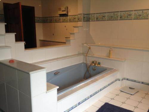 a bath tub in a bathroom with a mirror at The Farmhouse B&B in Goole