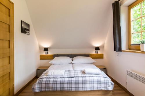 a bed in a small room with two pillows at udanypobyt Domek Górska Oaza in Kościelisko