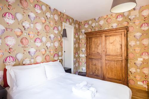 a bedroom with a bed and a wall with clocks at Salotto Monti in Rome