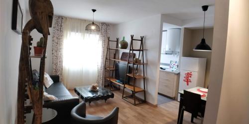 a living room with a couch a table and a kitchen at Zambra. Luminoso y coqueto apartamento en Chiclana in Chiclana de la Frontera