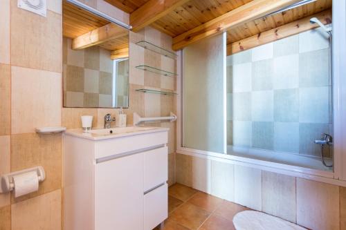 a bathroom with a sink and a mirror at Carol's Beco Apartments in Lagos