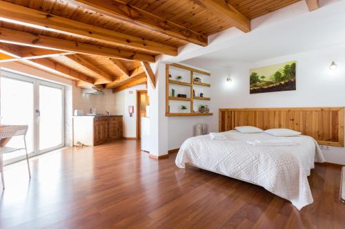 a bedroom with a bed and a wooden floor at Carol's Beco Apartments in Lagos