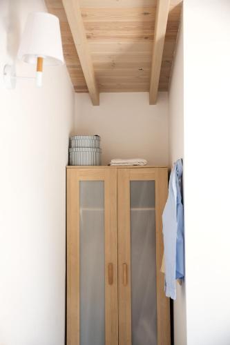 a room with a closet with a lamp and a cabinet at Sanidiamonds in Sani Beach