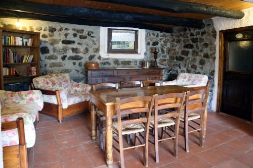 a dining room with a wooden table and chairs at B&B Rocca di Bajedo in Pasturo