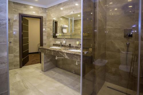 a bathroom with a sink and a shower at Maristella Marine Residence in Odesa
