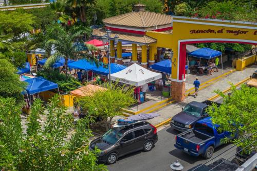 an overhead view of a street with cars parked in front of a market at Rincon Plaza Hotel in Rincon