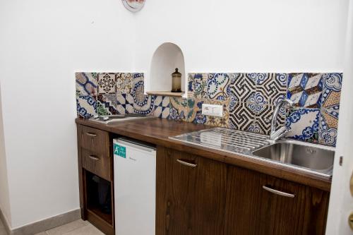 a kitchen with a sink and a counter top at Casetta Fuoro Guest House in Sorrento