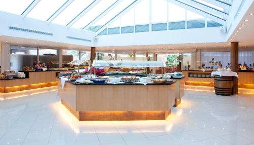 a restaurant with a buffet line in a building at Grupotel Gran Vista & Spa in Can Picafort