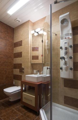 a bathroom with a sink and a toilet at Hotel Ženeva Lux in Kragujevac