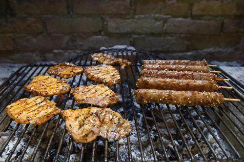 a bunch of food cooking on a grill at Treehouse Resnice -Mrežnica in Barilović
