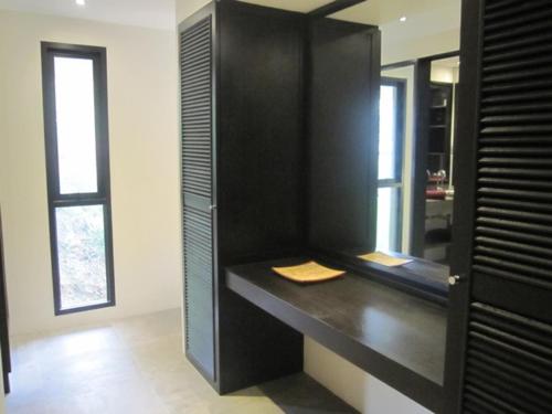 a bathroom with a black vanity with a mirror at Beachfront TalingNgam in Taling Ngam Beach