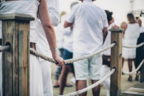 a group of people standing on a pier holding a rope at Club Marvy in Ozdere