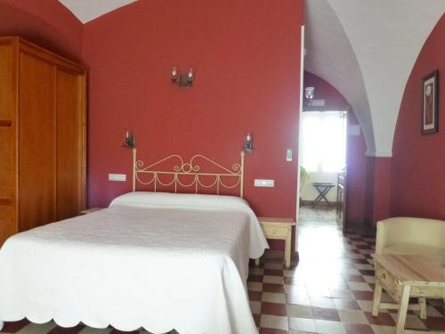 
a bedroom with a bed and a dresser at Hostal San Miguel in Trujillo
