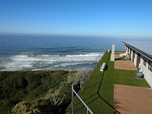 a balcony with a view of the ocean at Wilderness Beach Views in Wilderness