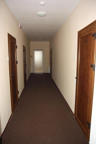 an empty hallway with a hallway leading to a door at Helen Hotel in Mykolaiv