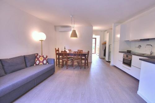 a living room with a couch and a dining room at La Briciola in Sirmione