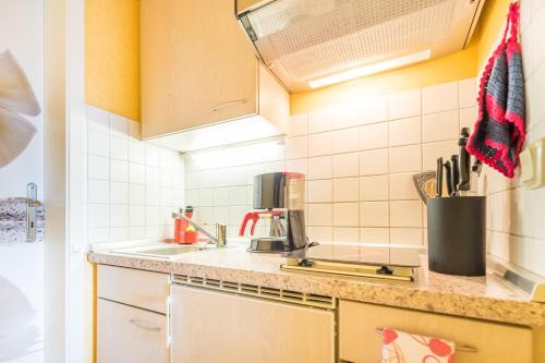 a kitchen with a sink and a counter top at Haus Mozart in Binz