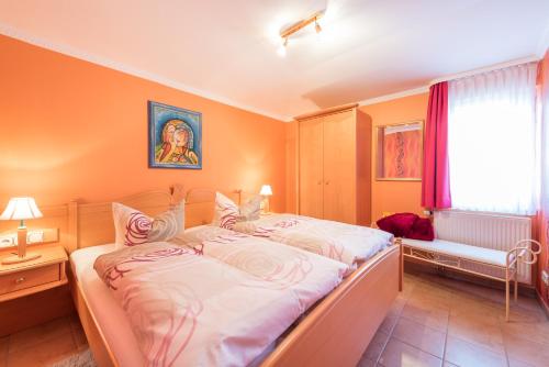 a bedroom with a large bed and a window at Haus Mozart in Binz