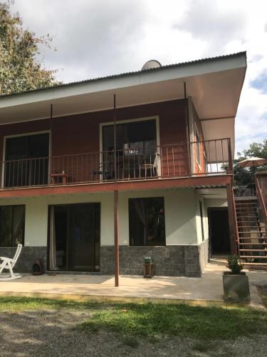 a house with a balcony and a deck at Villa Segura Manuel Antonio, Quepos in Quepos
