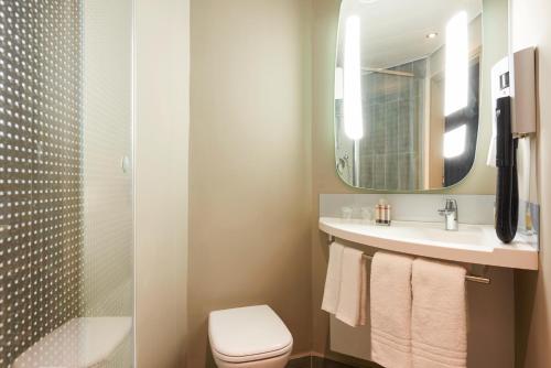 a bathroom with a sink and a toilet and a mirror at ibis Jerusalem city Center - An AccorHotels Brand in Jerusalem